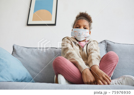 Girl Wearing Decorated Face Mask at Home Girl Wearing Decorated Face Mask at Home 75976930