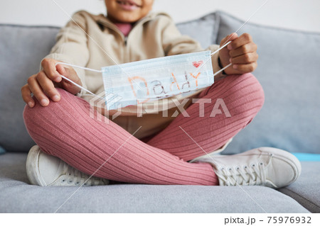 Girl Holding Face Mask for Dad Girl Holding Face Mask for Dad 75976932