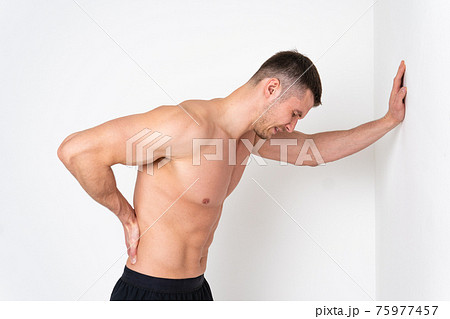 A man back pain keeps his hand on his back back painful, ill person caucasian young medicine, illness holding. Hold lumbar care, back suffer attractive 75977457