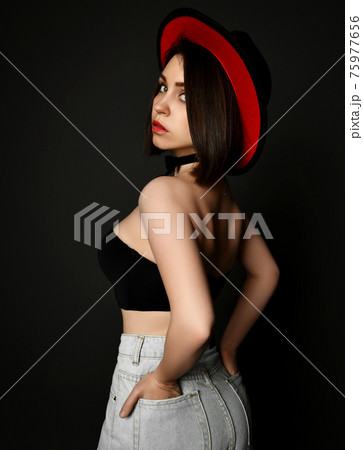 Pretty sexy brunette woman in top, jeans and hat Pretty sexy brunette woman in top, jeans and hat 75977656