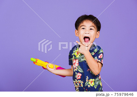Thai kid funny hold toy water pistol and smiling 75979646