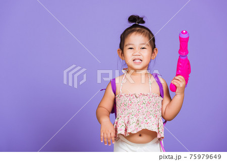 Thai child funny hold toy water pistol and smile 75979649