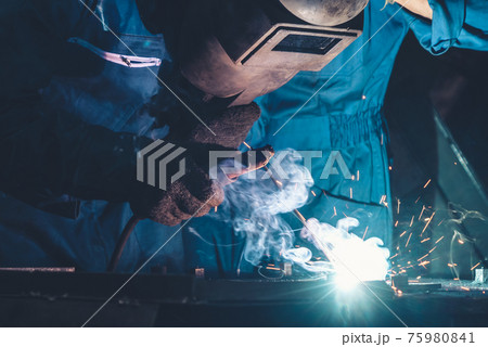 Skillful metal worker working with arc welding machine in factory Skillful metal worker working with arc welding machine in factory 75980841