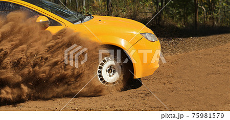 Rally race car drifting on dirt track. 75981579
