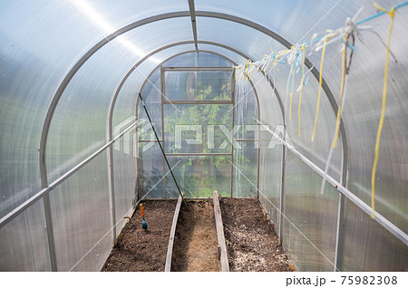 Empty small greenhouse in the countryside. Empty small greenhouse in the countryside. 75982308