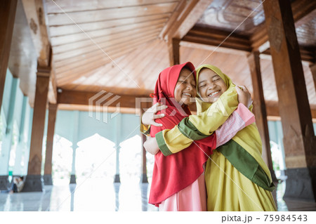 portrait asian kids girl Muslim laugh happiness and hug each other 75984543