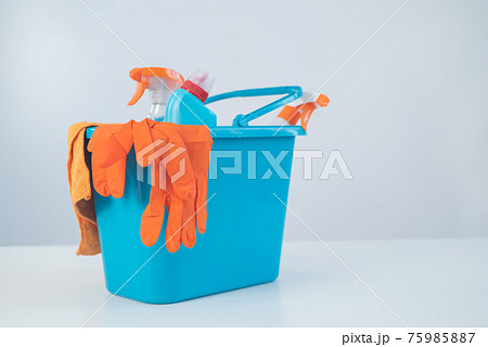 Blue bucket with cleaning products and rubber gloves for homework on a white background Blue bucket with cleaning products and rubber gloves for homework on a white background 75985887