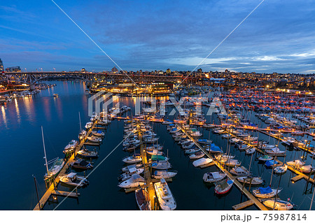 Granville Island Marina and Fishermen's Wharf Float at night. Vancouver city buildings skyline and Granville Bridge in the background. Vancouver, Canada. Granville Island Marina and Fishermen's Wharf Float at night. Vancouver city buildings skyline and Granville Bridge in the background. Vancouver, Canada. 75987814