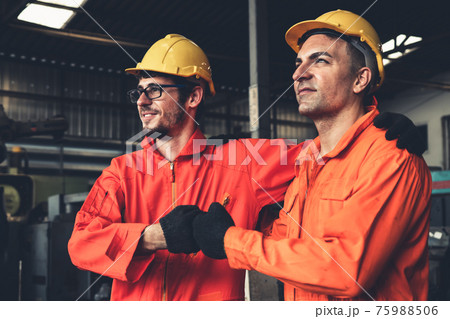 Two skillful factory engineer or worker showing teamwork and partnership . 75988506
