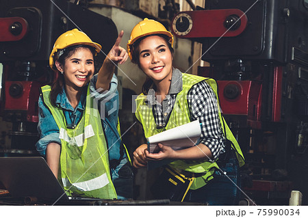 Factory job workers working and discussing manufacturing plan in the factory Factory job workers working and discussing manufacturing plan in the factory 75990034