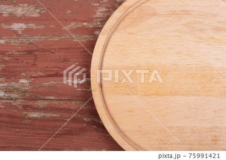 Cutting board for cutting bread, pizza or steak on a wooden background. Cutting board for cutting bread, pizza or steak on a wooden background. 75991421