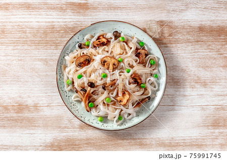 Konjac pasta with mushrooms and green peas, a healthy low-calorie dinner Konjac pasta with mushrooms and green peas, a healthy low-calorie dinner 75991745