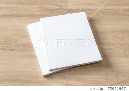 Book cover mockup with blank white front paper page a4 paperback mock up for catalog, magazine, menu, booklet, notebook, portfolio design template on wood table background 75991967