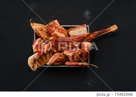 Variety of air dried and smoked lamb and beef meat in wooden box Variety of air dried and smoked lamb and beef meat in wooden box 75992006