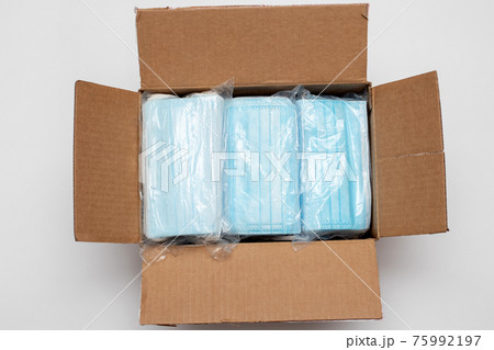Disposable face masks in a package . Medical mask in the box ready to shipment. 75992197