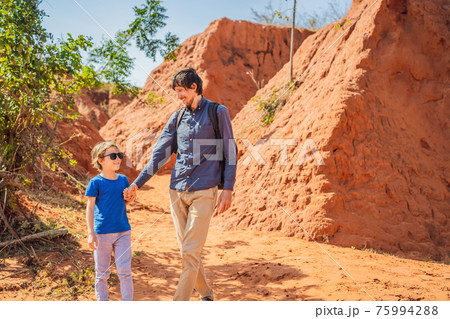Dad and son tourists in red canyon, resumption of tourism concept. Traveling with children concept 75994288