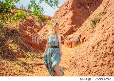 Woman tourist in red canyon, resumption of tourism concept 75994292
