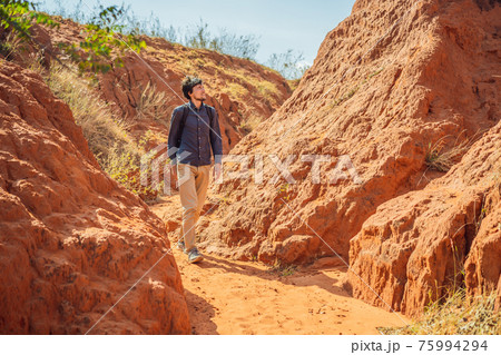 Man tourist in red canyon, resumption of tourism concept 75994294