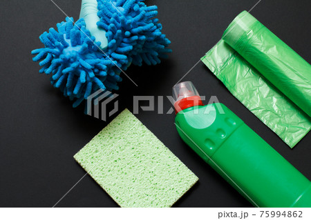 Hand with a rag and a cleaning set on a black background. Hand with a rag and a cleaning set on a black background. 75994862