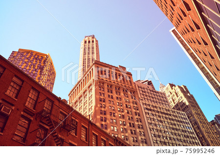 Looking up at Manhattan buildings, color toned picture, New York City, USA. Looking up at Manhattan buildings, color toned picture, New York City, USA. 75995246