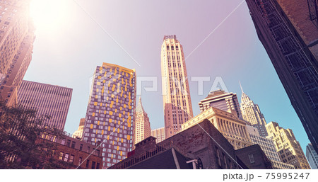 Looking up at Manhattan buildings, color toned picture, New York City, USA. Looking up at Manhattan buildings, color toned picture, New York City, USA. 75995247