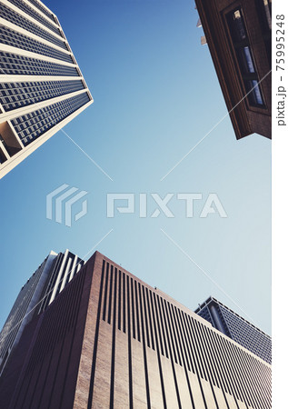 Looking up at New York skyscrapers, color toned picture, USA. Looking up at New York skyscrapers, color toned picture, USA. 75995248