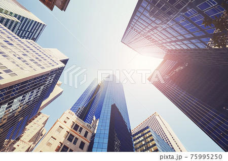 Looking up at New York skyscrapers, color toned picture, USA. 75995250