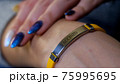 Female hand with vaccined bracelet or label after injection 75995695