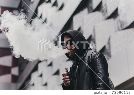 Vaping man holding a mod Vaping man holding a mod 75996115