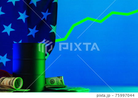 Price of american oil is changing concept. Black barrel with oil and graph 75997044