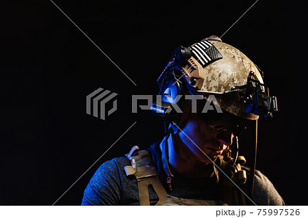 Portrait of special forces soldier in helmet and glasses in the dark Portrait of special forces soldier in helmet and glasses in the dark 75997526