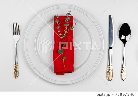 Empty plate with cutlery isolated on white background 75997546