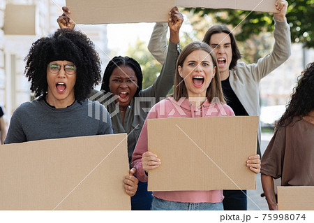 Furious mutiracial group of demonstrators protesting on the street, closeup 75998074