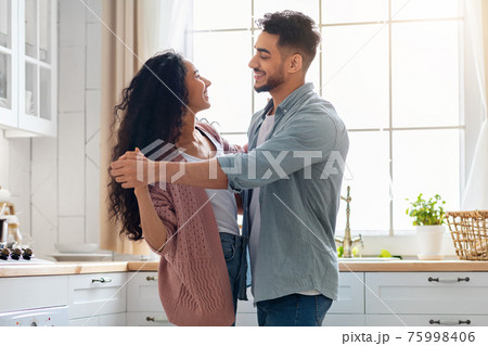 Young Family Life. Loving Middle Eastern Spouses Dancing In Cozy Kitchen Interior 75998406