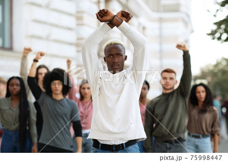 Black guy activist leading international group of young people Black guy activist leading international group of young people 75998447