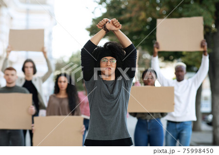 Young man activist leading international group of students 75998450
