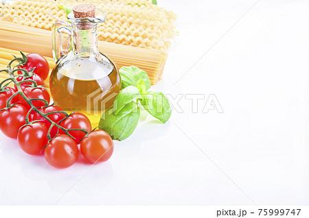 Pasta with fresh tomatoes, basil and olive oil on light shabby rustic background, top view, border 75999747