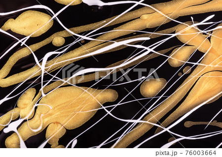 Abstract fluid art background black and golden colors. Liquid marble. Acrylic painting with white lines and gradient. 76003664