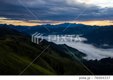 Early morning in the mountains. The sun rises over the mountains. Dawn in the mountains. 76004337