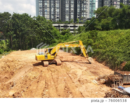 Excavators machine at the construction site. It is used to excavate and lifting soil and other material at the construction site. Powered by the hydraulic arm with a bucket. Excavators machine at the construction site. It is used to excavate and lifting soil and other material at the construction site. Powered by the hydraulic arm with a bucket. 76006538