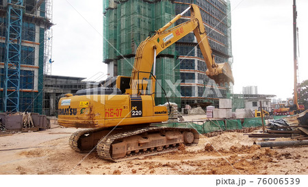 Excavators machine at the construction site. It is used to excavate and lifting soil and other material at the construction site. Powered by the hydraulic arm with a bucket. Excavators machine at the construction site. It is used to excavate and lifting soil and other material at the construction site. Powered by the hydraulic arm with a bucket. 76006539