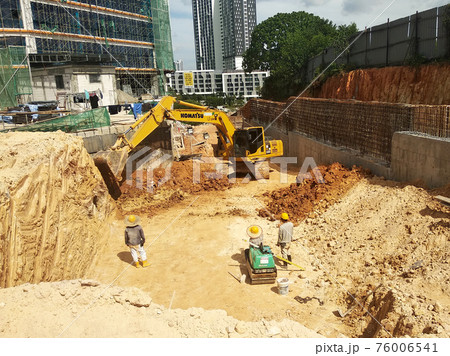 Excavators machine at the construction site. It is used to excavate and lifting soil and other material at the construction site. Powered by the hydraulic arm with a bucket. Excavators machine at the construction site. It is used to excavate and lifting soil and other material at the construction site. Powered by the hydraulic arm with a bucket. 76006541
