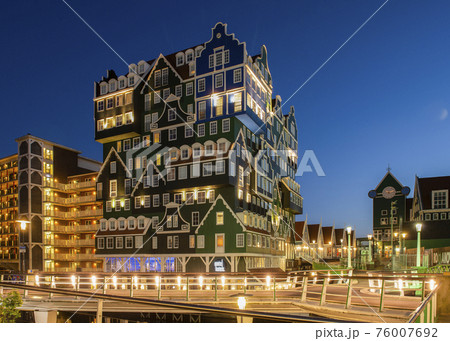 Zaandam, Netherlands - May, 11 2018; Famous touristic Inn hotel in Zaanstad with a exterior of old dutch houses, The Netherlands in the evening. 76007692