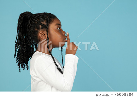 Handsome african little girl portrait isolated on blue studio background with copyspace 76008284