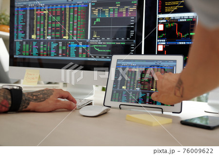 Trader checking stock market Trader checking stock market 76009622