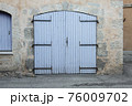 Closed large blue door in an old house in the Provence, France 76009702