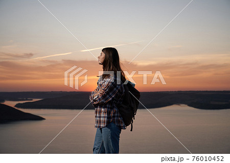 Attractive woman hiking at Bakota bay during summer sunset Attractive woman hiking at Bakota bay during summer sunset 76010452