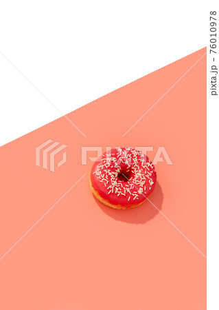 Tasty pink donut on creative background with deep long shadow Tasty pink donut on creative background with deep long shadow 76010978