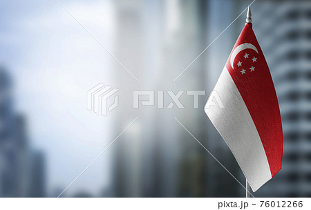 A small flag of Singapore on the background of a blurred background A small flag of Singapore on the background of a blurred background 76012266