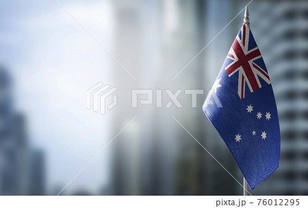 A small flag of Australia on the background of a blurred background 76012295